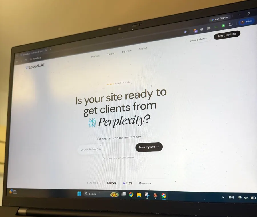 The LovedByAI homepage open on a laptop